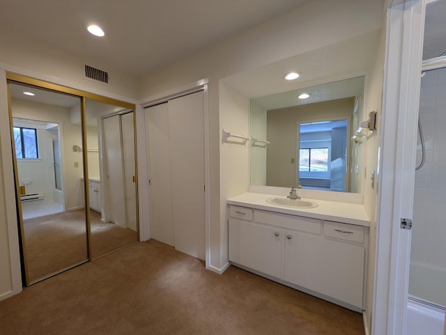 bathroom with vanity and a baseboard heating unit