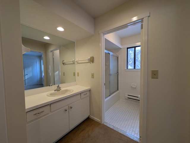 bathroom with enclosed tub / shower combo, a baseboard radiator, vanity, and tile patterned floors