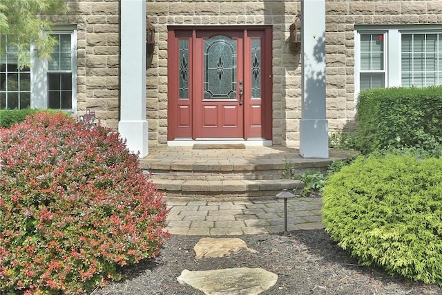 view of exterior entry featuring stone siding