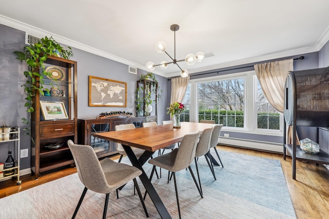 dining area with visible vents, an inviting chandelier, a baseboard heating unit, ornamental molding, and light wood-type flooring