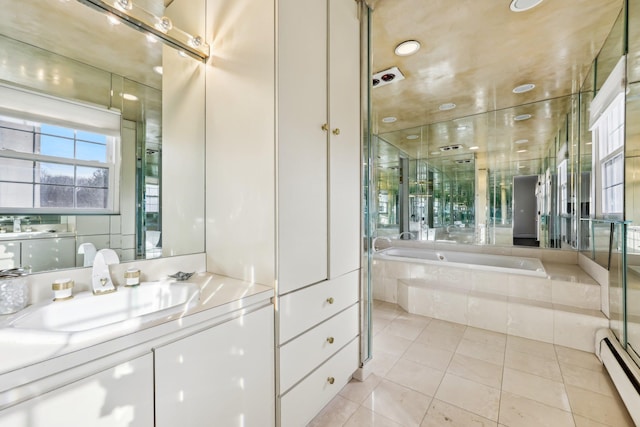 full bathroom featuring a baseboard heating unit, tile patterned flooring, vanity, and a bath