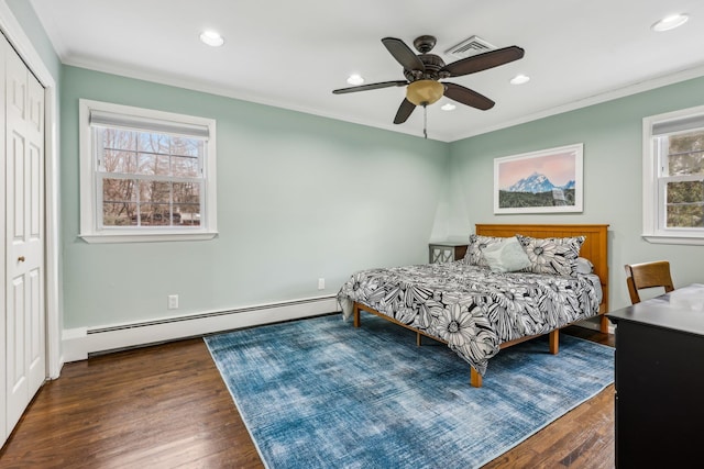 bedroom featuring a baseboard radiator, wood finished floors, crown molding, a closet, and recessed lighting