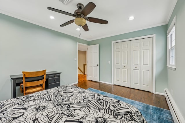 bedroom featuring a baseboard heating unit, ornamental molding, baseboards, and wood finished floors