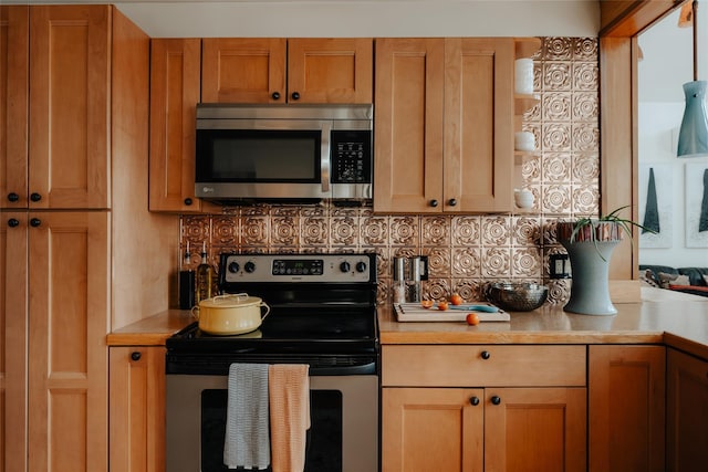 kitchen featuring stainless steel appliances and decorative backsplash