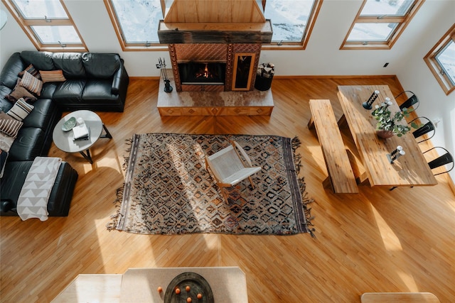 living room featuring wood-type flooring and a skylight