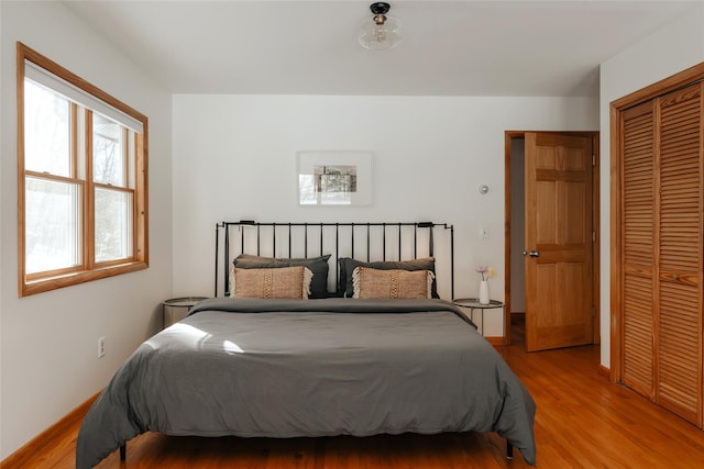 bedroom featuring light hardwood / wood-style floors and a closet