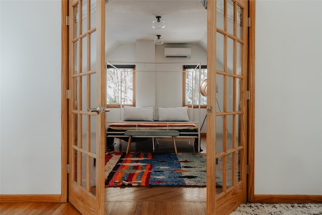 hall featuring hardwood / wood-style flooring and a wall mounted AC