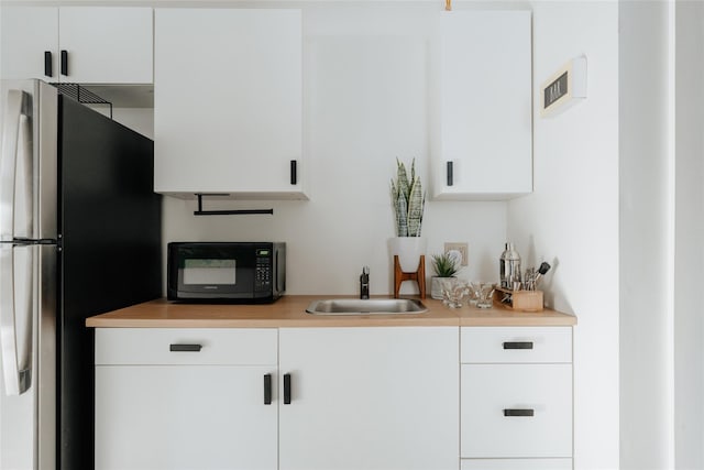 kitchen featuring sink and white cabinets