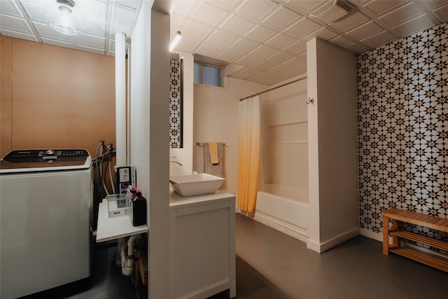 bathroom with shower / tub combo, sink, washer / dryer, and concrete flooring