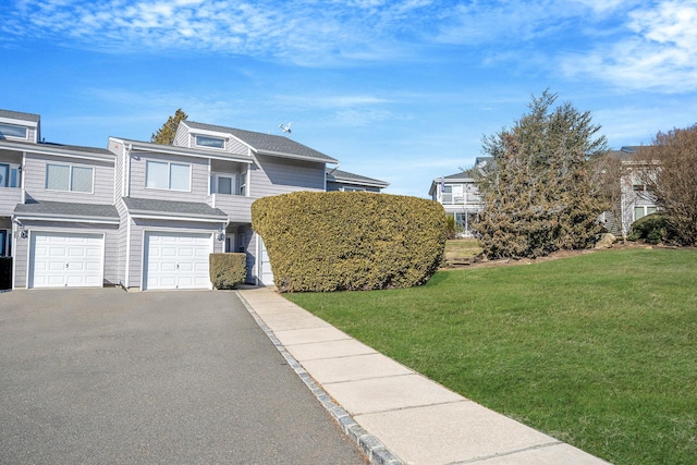 view of front of house featuring a garage and a front lawn