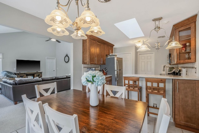 dining space featuring a skylight and ceiling fan