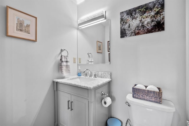 bathroom featuring toilet and vanity