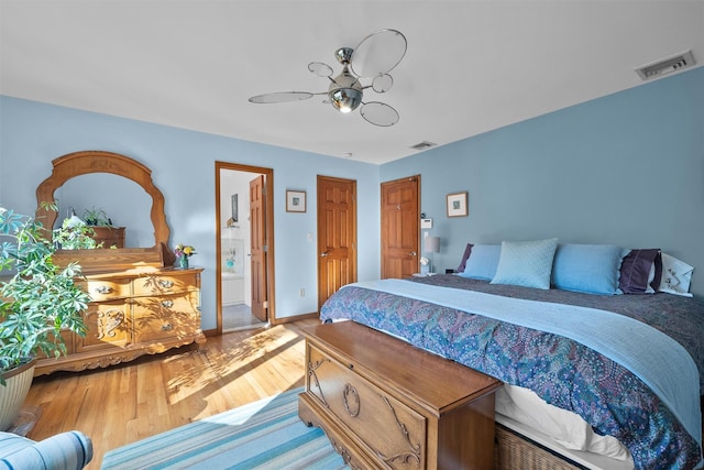 bedroom featuring hardwood / wood-style floors and connected bathroom