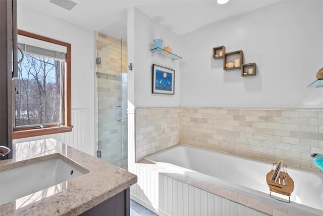 bathroom featuring separate shower and tub and vanity