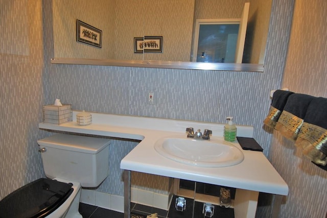 bathroom featuring sink, tile patterned floors, and toilet