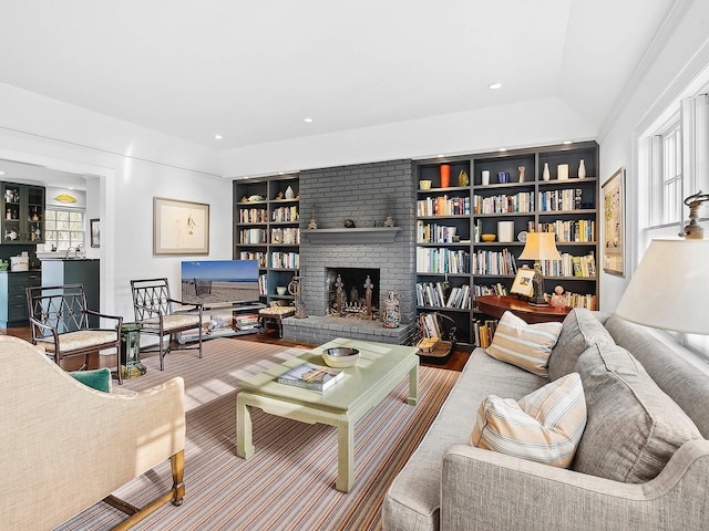 living room with built in shelves and a fireplace