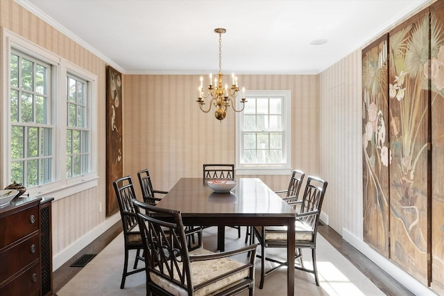 dining area featuring ornamental molding, a chandelier, and light hardwood / wood-style floors