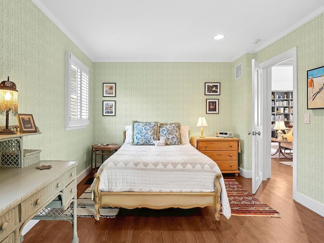 bedroom featuring crown molding and hardwood / wood-style flooring