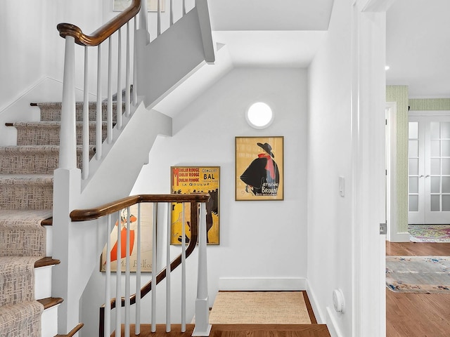 stairway with hardwood / wood-style floors