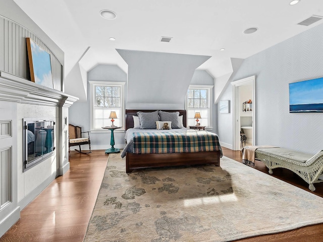 bedroom with hardwood / wood-style flooring and lofted ceiling