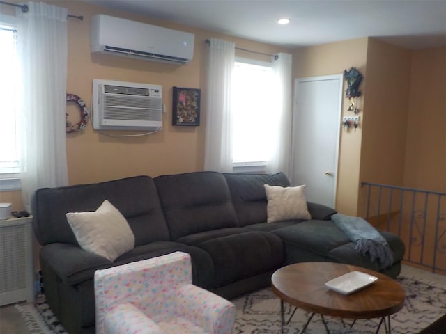 living room featuring an AC wall unit