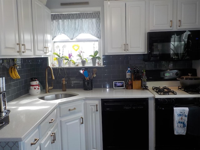 kitchen with white cabinetry, sink, and black appliances