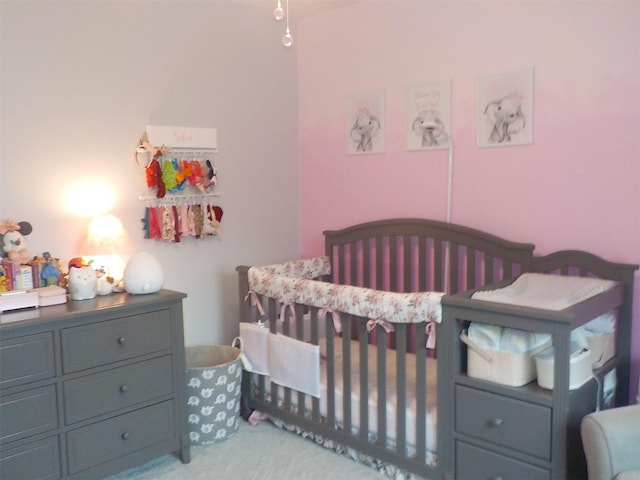 bedroom featuring a nursery area