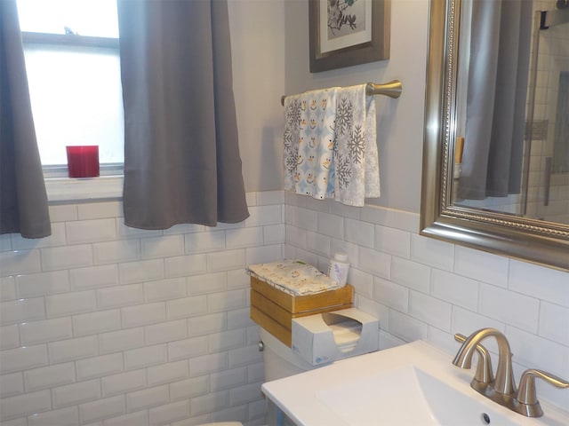 bathroom featuring tile walls and sink