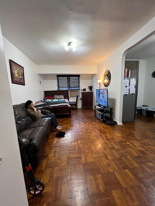 living room featuring dark parquet flooring