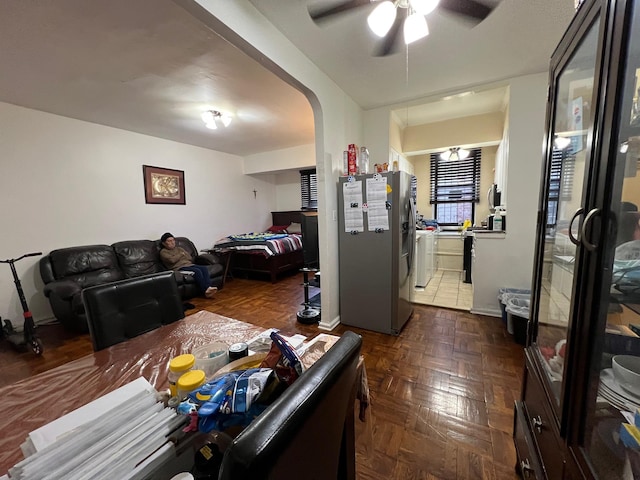 living room featuring dark parquet floors and ceiling fan