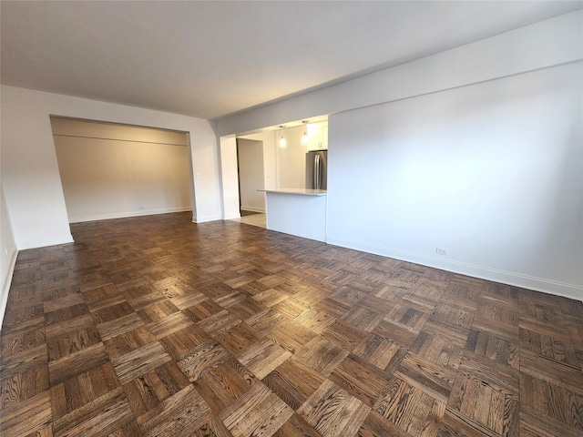 spare room with dark parquet flooring