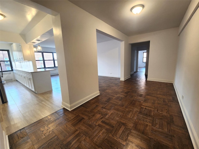 spare room featuring dark parquet floors