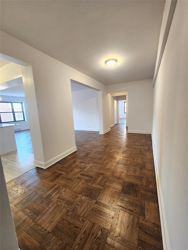 unfurnished room featuring dark parquet floors