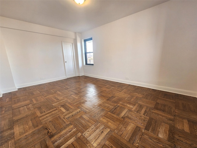 empty room featuring dark parquet flooring