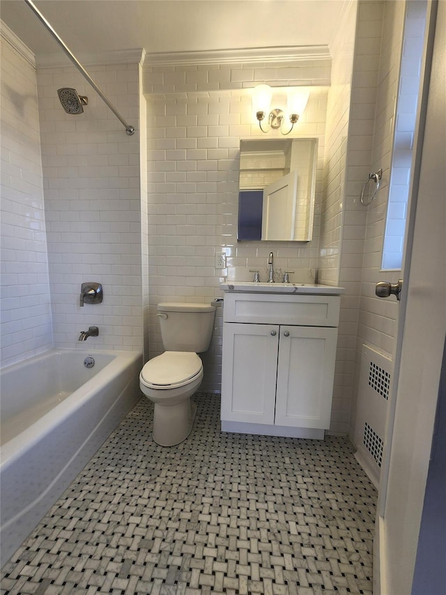 full bathroom with radiator, tiled shower / bath combo, vanity, ornamental molding, and toilet