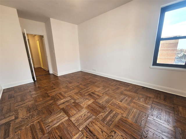 unfurnished room with dark parquet floors