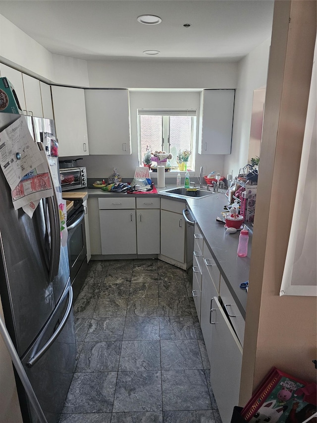 kitchen featuring white cabinetry, appliances with stainless steel finishes, and sink