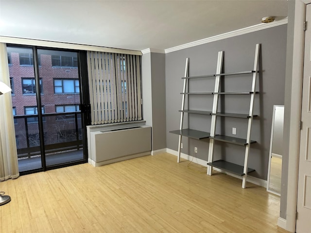 spare room with crown molding and hardwood / wood-style flooring