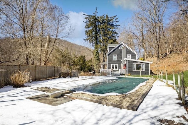 snow covered pool featuring a mountain view and a diving board