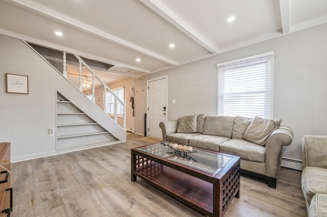 living room featuring a baseboard heating unit, plenty of natural light, beamed ceiling, and light hardwood / wood-style floors