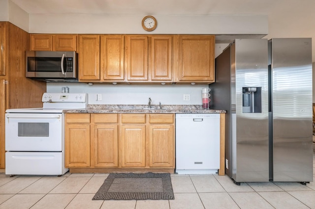 kitchen featuring light tile patterned floors, sink, and stainless steel appliances