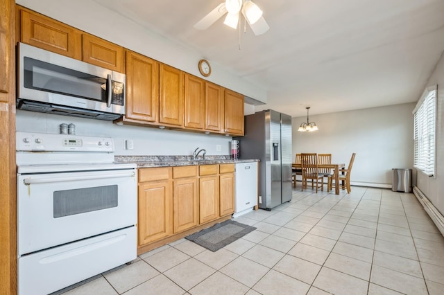 kitchen featuring appliances with stainless steel finishes, light tile patterned flooring, hanging light fixtures, and ceiling fan with notable chandelier