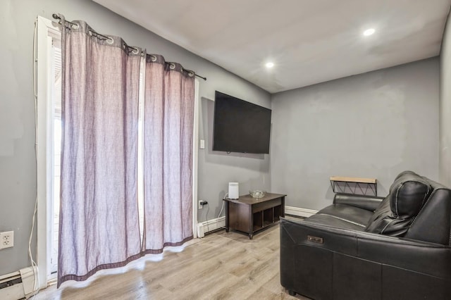 living area featuring light hardwood / wood-style flooring and a baseboard radiator