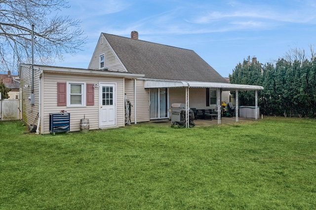 rear view of house with a patio area and a yard