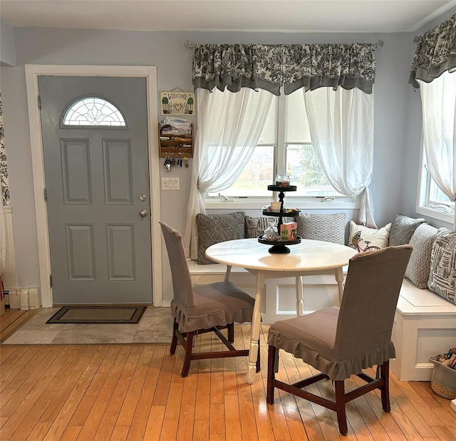 living area with breakfast area and light hardwood / wood-style floors