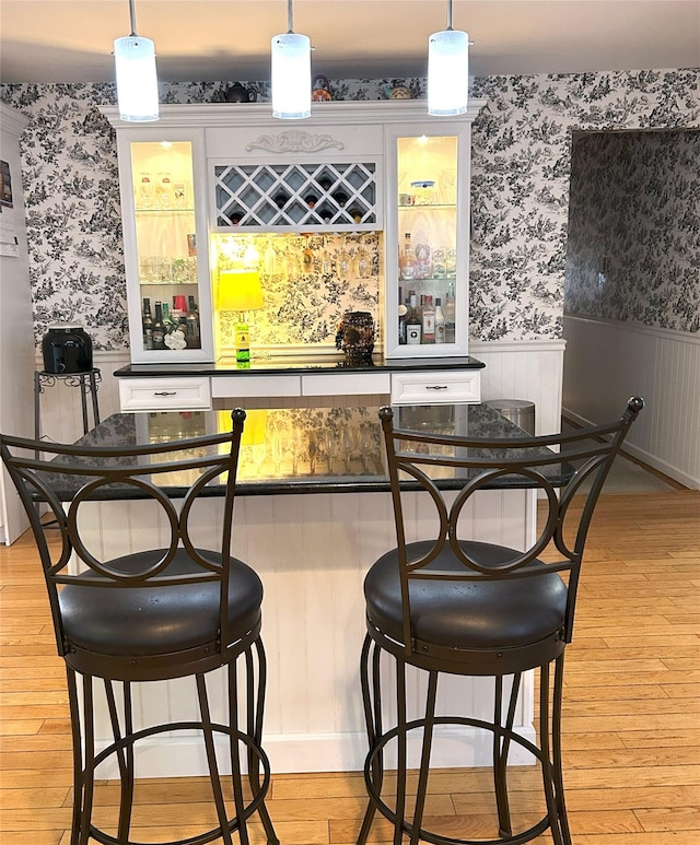 bar featuring pendant lighting and light wood-type flooring