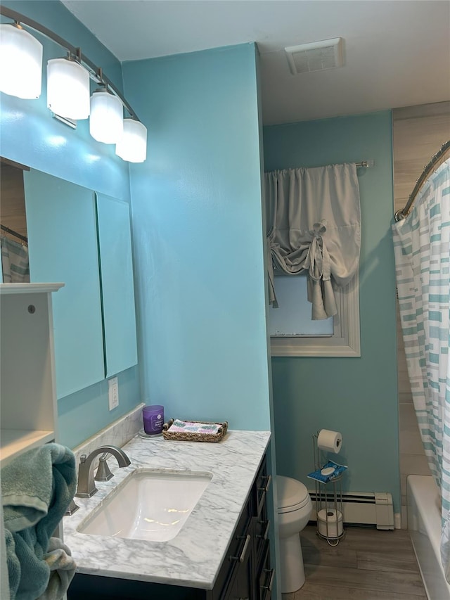 full bathroom with shower / bathtub combination with curtain, a baseboard heating unit, hardwood / wood-style floors, vanity, and toilet