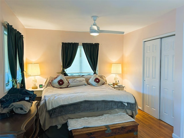 bedroom featuring ceiling fan, wood-type flooring, and a closet