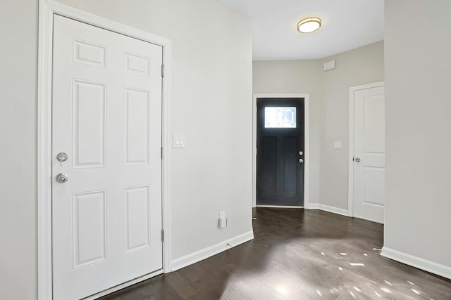 foyer with baseboards and wood finished floors