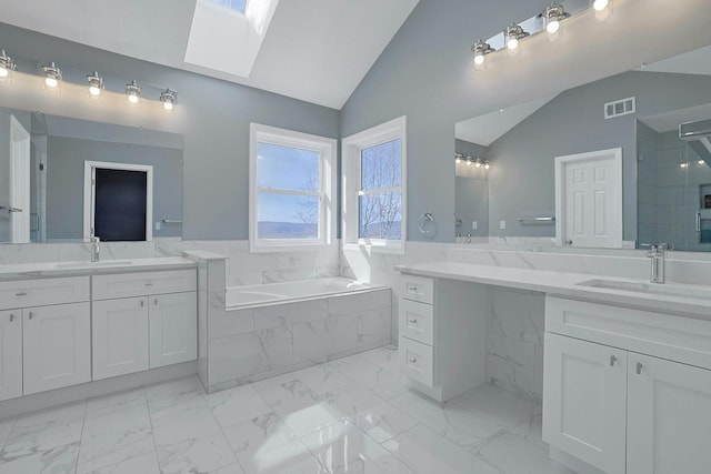 bathroom featuring a garden tub, visible vents, a stall shower, a sink, and lofted ceiling with skylight